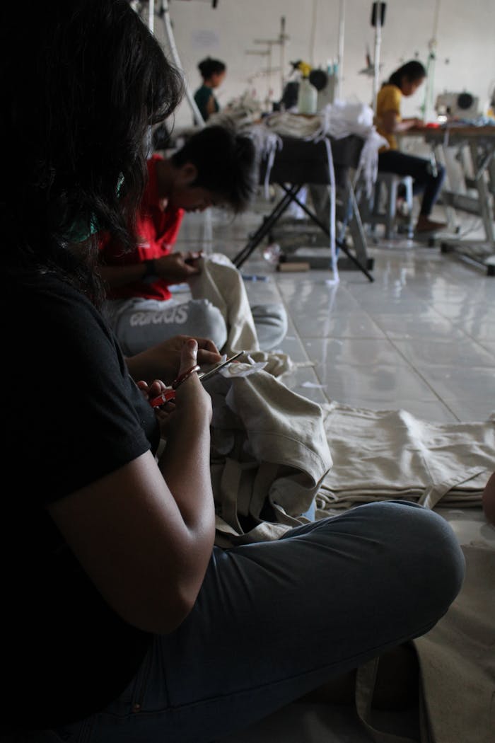 Skilled workers at a Bali sewing factory, focused on garment crafting and textile production.
